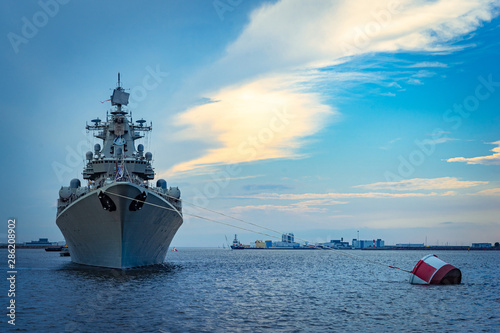 Missile cruiser. Military ship against the backdrop of a beautiful sky. Naval forces. Protection of maritime borders. The destroyer guards the strait at sea.
