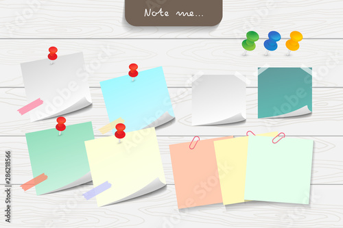 Set of different note papers on wooden background.