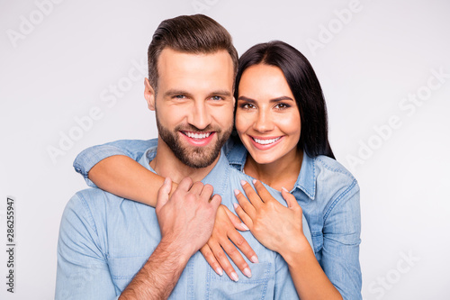 Close up photo of sweet lady and guy with toothy smile cuddling wearing denim jeans shirt isolated over white background