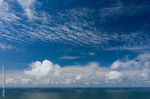 Peaceful sea and cloudy blue sky. Horizon line.