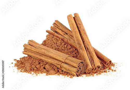 Ceylon cinnamon sticks with powder on a white background