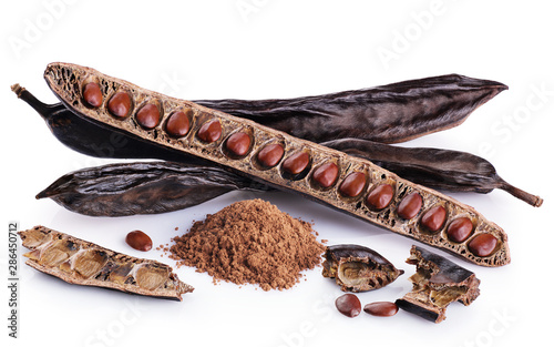 Carob pods, bean and carob powder isolated on white background.