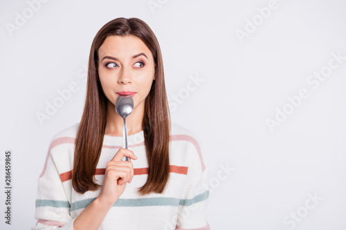 Very hungry lady holding spoon into mouth dream of tasty meal wear striped pullover isolated white background