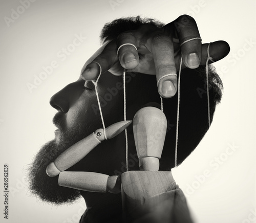 Marionette in male head, black and white. Concept of mind control. Image