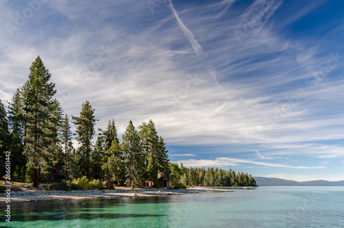USA, California, El Dorado County, D.L. Bliss State Park. The shoreline and green waters of Lake Tahoe on a day with whispy clouds.