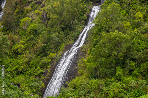 Waterfall on a green mountain at french island Reunion in the indian ocean