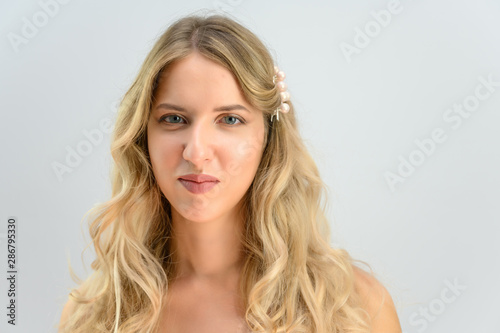 A large photo portrait of a pretty model with long hair and a beautiful hairstyle on a white background.