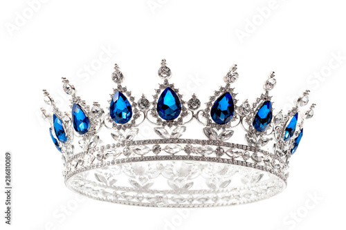Beauty pageant winner, bride accessory in wedding and royal crown for a queen concept with a silver tiara covered diamonds and blue sapphire stones isolated on white with clipping path cutout