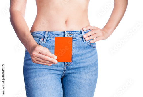 Woman holding red card at waist.