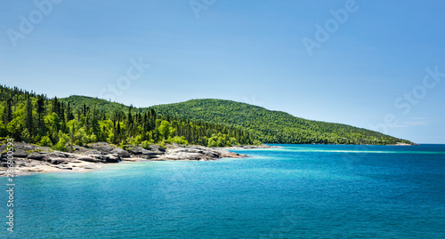 Scenic view of the forest across the beautiful Blue water of Lake Superior at Neys Provincial Park, Ontario, Canada