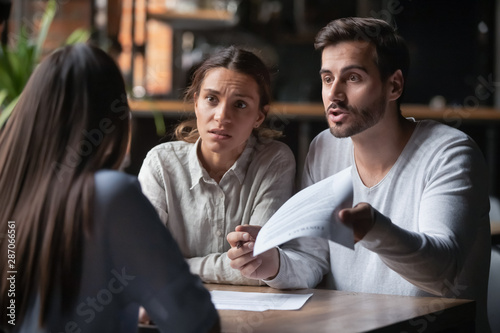 Angry couple arguing with bank manager complain on bad contract