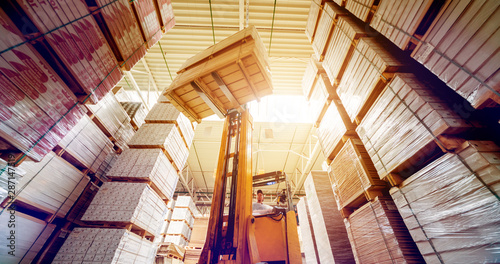 Forklift loader in storage warehouse ship yard. Distribution products. Delivery. Logistics. Transportation.