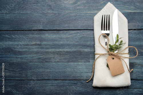 table setting. cutlery. Fork, knife in a white napkin on a blue wooden table. top view