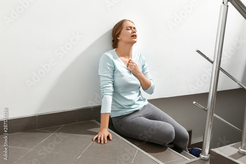 Woman having panic attack in the stairway