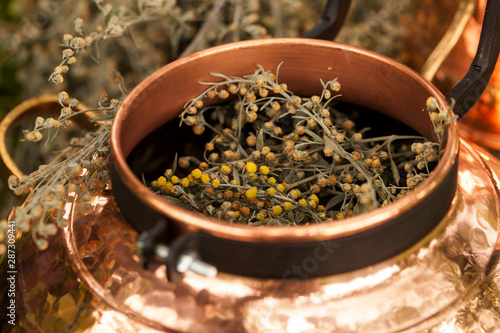 Alembic is a distilling apparatus of Arabic origin which may be used to distill essential oils and a variety of alcoholic beverages. Artemisia abisinthium distillation.