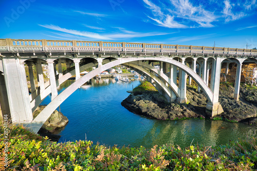 U.S. 101 highway over the entrance to Depoe Bay, Oregon, touted as the world's smallest natural navigable harbor. Its narrow, 50 foot wide channel (below bridge) leads directly to the Pacific Ocean.