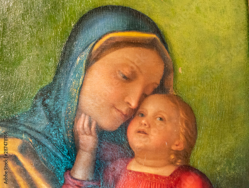 Detail of medieval italian fresco showing love between Mary and baby Jesus
