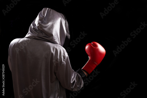 Professional boxer with boxing gloves on dark background.