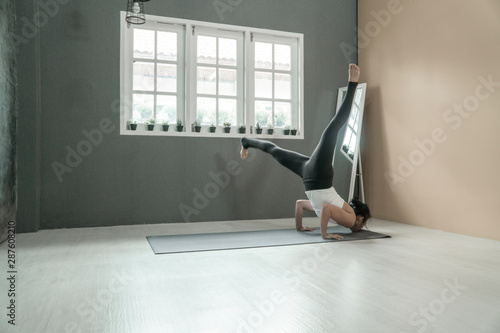 beautiful woman relaxing and stretching practicing yoga on the floor in home, yoga concept, fitness concept