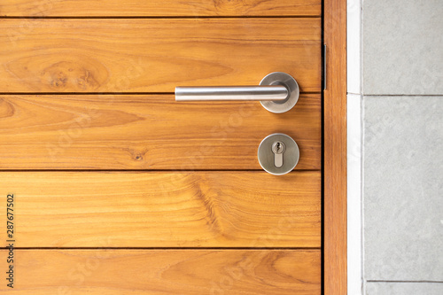 Stainless steel door handle and wooden door