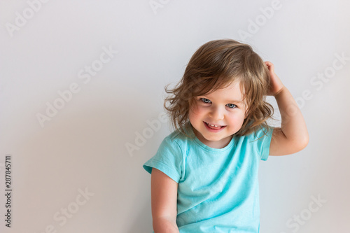 Happy laughing baby toddler kid on light background 