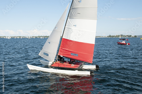 Children Sailing a catamaran sailboat at speed with one hull air