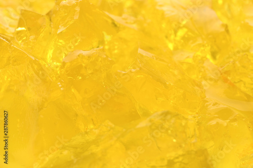 Yellow tasty fruit jelly as background, closeup