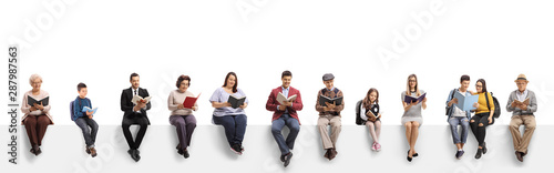 Old and young people sitting on a banner reading books