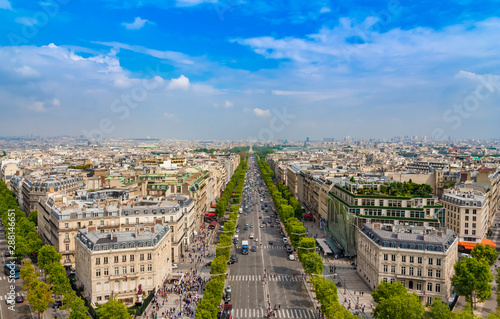 Lovely panoramic aerial view of the famous Avenue des Champs-Élysées in Paris on a nice sunny day with a blue sky at the horizon. It is one of the most recognisable avenues in the world.