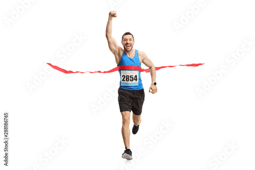 Man finishing a marathon and gesturing happiness with hand