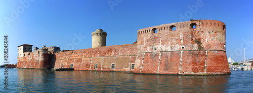 Moated Fortezza Vecchia Castle with its thick waterfront walls in Livorno, Italy