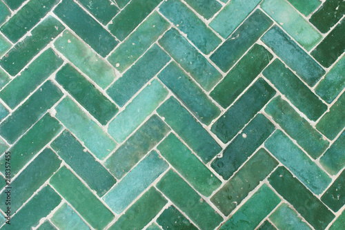 Green tile floor decorated outdoors.