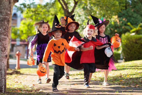 Kids trick or treat. Halloween fun for children.