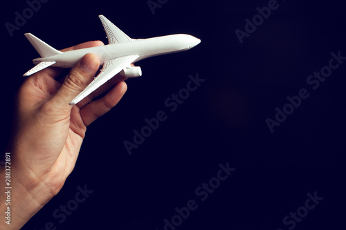 businessman hand holding an airplane toy model in transportation business for travel tourist international concept, summer season holiday vacation, logistic import export