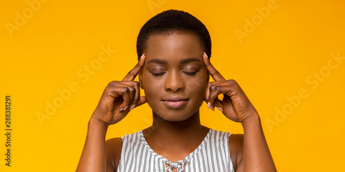 African american woman thinking hard with eyes closed