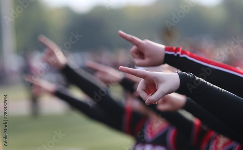 high school cheerleaders point as part of a routine
