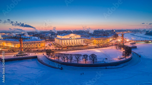 Saint-Petersburg. Russia. Arrow Vasilievsky evening panorama. Embankment of Vasilievsky island in winter. Neva river in ice. Bridges of St. Petersburg. City of Russia. Travelling to Saint Petersburg.