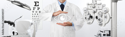 concept of eye examination, optician hands protecting an eye icon, prevention and control, on background tools for diagnostics, web banner