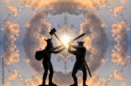 Two silhouettes of armed Viking warriors with axe and sword against sky with circle of clouds and bright sun