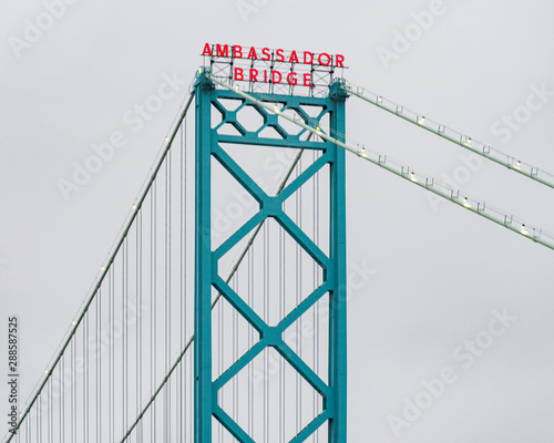 Suspension bridge's name lit on cloudy day