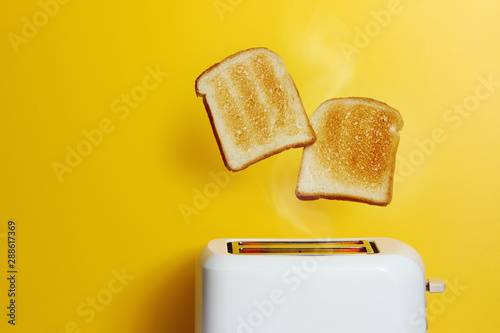 Slices of toast jumping out of the toaster
