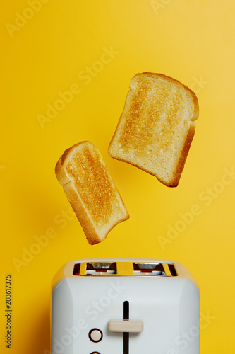 Slices of toast jumping out of the toaster