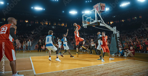 Basketball players on big professional arena during the game. Tense moment of the game. Celebration