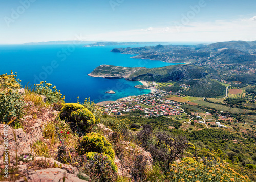 Colorful morning view of Paralia Kakis Thalassis village. Bright spring seascape of Aegean sea. Sunny morning scene of the Greece, Europe. Beauty of nature concept background.