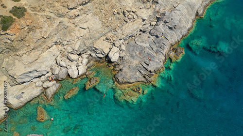 Aerial drone photo of iconic small chapel of Agia Anna built just above emerald rocky pebble beach, Amorgos island, Cyclades, Greece