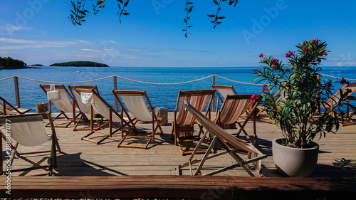 Wooden floor with chaise-longues and tables in Istria, Croatian coast