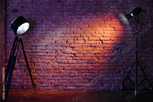 Old retro red brick wall being lit by a stage light bulb light. Constant light modifier projecting light on it