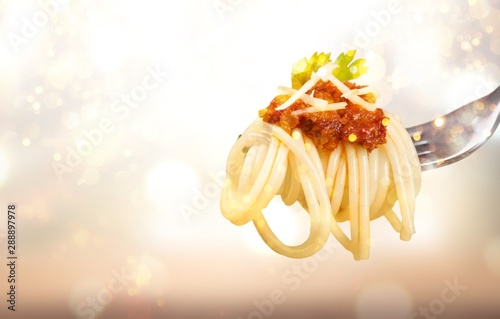 Fork with just spaghetti on blurred empty background