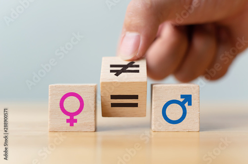 Concepts of gender equality. Hand flip wooden cube with symbol unequal change to equal sign