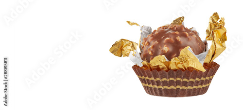 Beautiful chocolate candy ball shape in an open gold wrapper isolated on white with shadows and copy space for your text. Full sharpness across the entire frame field.